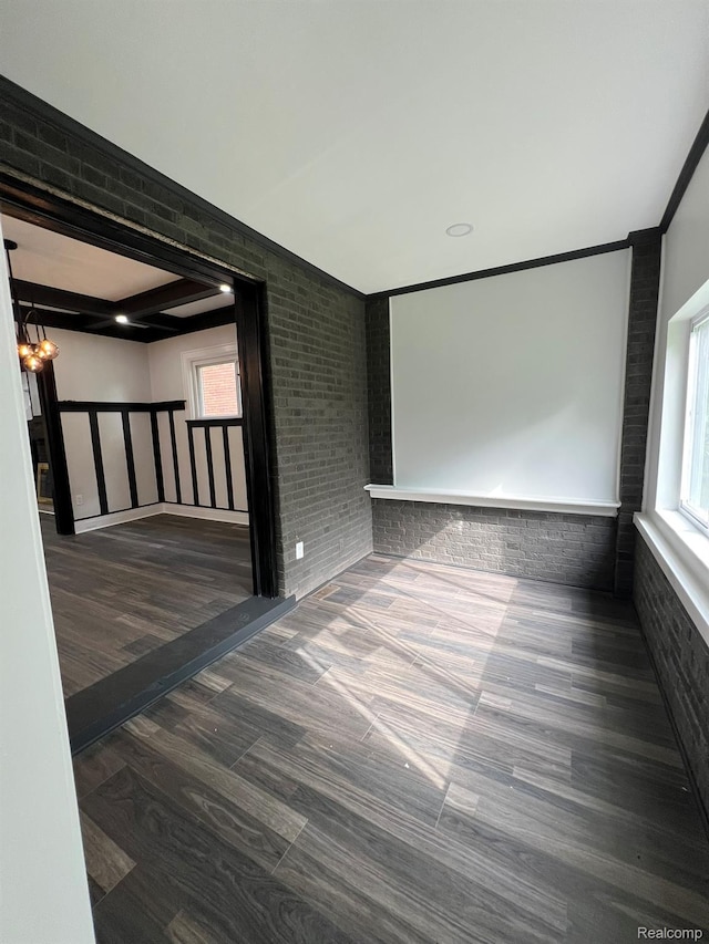 3431 Field St, Detroit, MI 48214 - spare room with wood finished floors, brick wall, and ornamental molding
