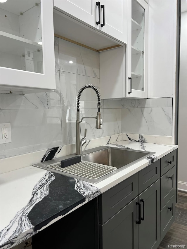 3431 Field St, Detroit, MI 48214 - kitchen with glass insert cabinets, light countertops, tasteful backsplash, white cabinets, and gray cabinetry
