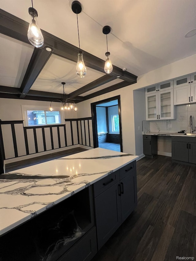3431 Field St, Detroit, MI 48214 - kitchen with healthy amount of natural light, beamed ceiling, glass insert cabinets, dark wood-type flooring, and pendant lighting