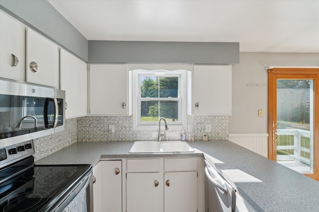15730 Cedar Springs Ave NE, Cedar Springs, MI 49319 - kitchen with appliances with stainless steel finishes, tasteful backsplash, white cabinetry, and light countertops