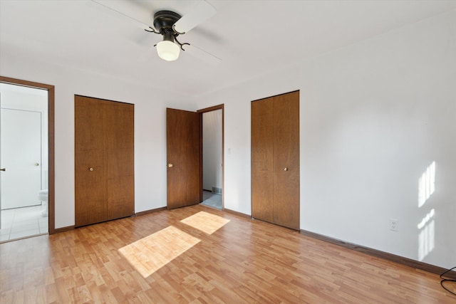 15730 Cedar Springs Ave NE, Cedar Springs, MI 49319 - unfurnished bedroom featuring light wood-style floors, connected bathroom, and a ceiling fan