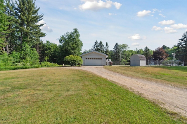 15730 Cedar Springs Ave NE, Cedar Springs, MI 49319 - view of yard featuring an outdoor structure, dirt driveway, and a detached garage