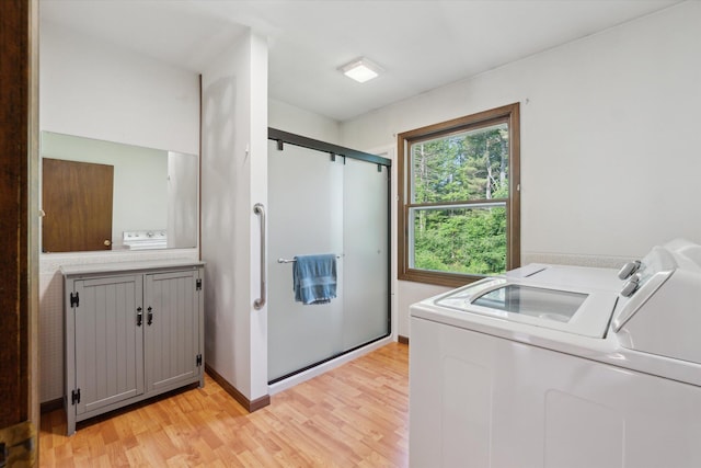 15730 Cedar Springs Ave NE, Cedar Springs, MI 49319 - laundry area with washing machine and dryer and light wood-style flooring