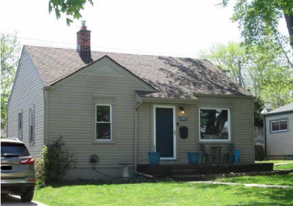 2003 Moran Ave, Lincoln Park, MI 48146 - bungalow with a front yard, a chimney, covered porch, and roof with shingles