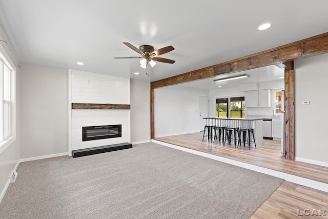 6027 Onsted Hwy, Onsted, MI 49265 - living room with recessed lighting, ceiling fan, a fireplace, and light wood-type flooring