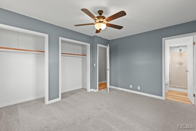 6027 Onsted Hwy, Onsted, MI 49265 - unfurnished bedroom with multiple closets, carpet floors, a ceiling fan, and connected bathroom