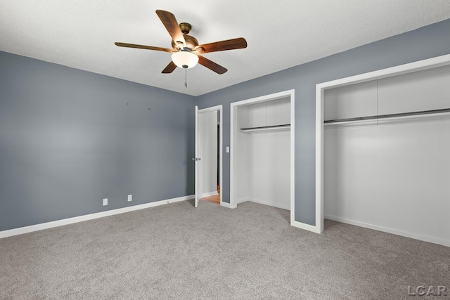6027 Onsted Hwy, Onsted, MI 49265 - unfurnished bedroom featuring two closets, carpet, and a ceiling fan
