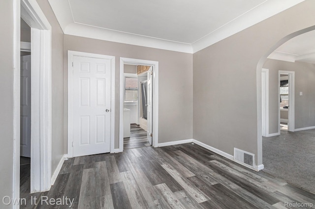 198 Fairmont St, Wyandotte, MI 48218 - spare room with arched walkways and dark wood finished floors