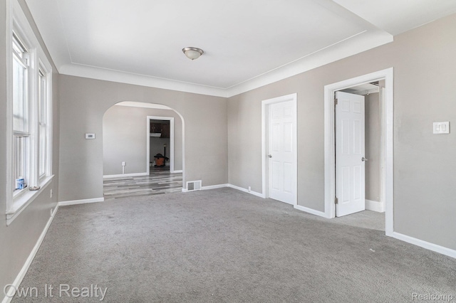 198 Fairmont St, Wyandotte, MI 48218 - empty room with arched walkways and carpet flooring
