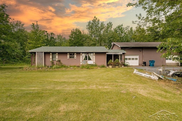 2190 S Coleman Rd, Shepherd, MI 48883 - back of property with an attached garage, a yard, and view of scattered trees