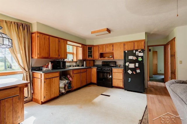 2190 S Coleman Rd, Shepherd, MI 48883 - kitchen featuring black appliances, brown cabinets, and dark countertops