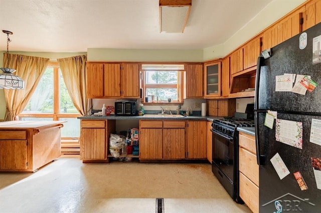 2190 S Coleman Rd, Shepherd, MI 48883 - kitchen featuring black appliances, brown cabinetry, dark countertops, and open shelves