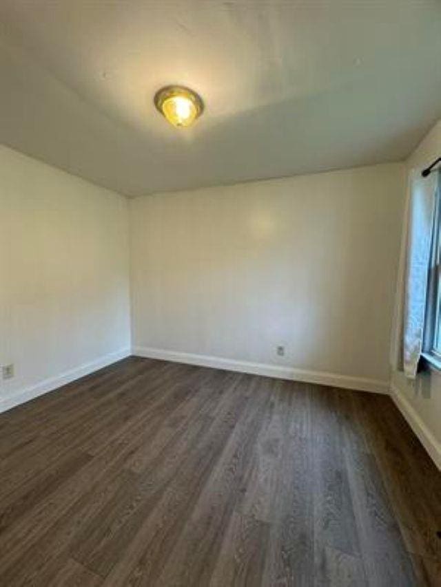 3148 Woodrow Ave, Flint, MI 48506 - spare room with dark wood finished floors and baseboards