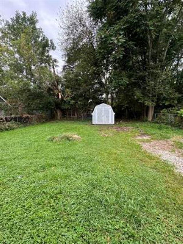 3148 Woodrow Ave, Flint, MI 48506 - view of green lawn featuring a storage unit