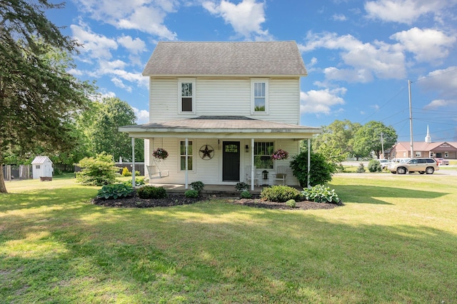 8015 Bloomer St, Carson City, MI 48811 - view of front facade featuring covered porch, a shed, a front lawn, and roof with shingles