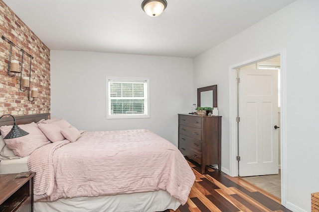 8015 Bloomer St, Carson City, MI 48811 - bedroom with wood finished floors and brick wall