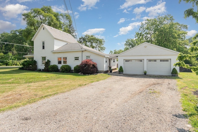 8015 Bloomer St, Carson City, MI 48811 - view of front of home featuring a front yard, a shingled roof, and a detached garage