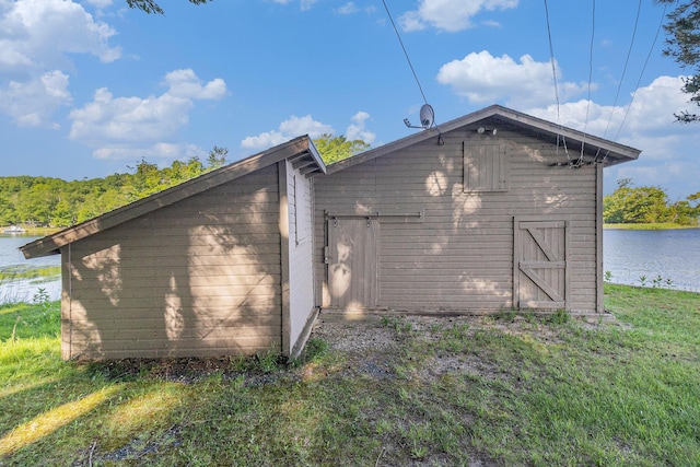 6253 Loggers Ln, Ludington, MI 49431 - view of side of property with a water view and an outbuilding