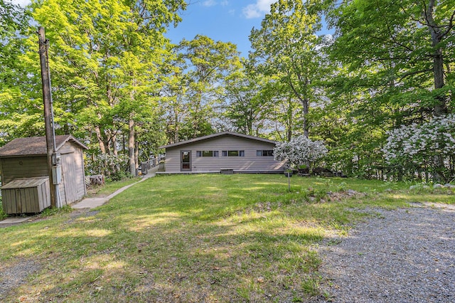 6253 Loggers Ln, Ludington, MI 49431 - view of green lawn with a shed
