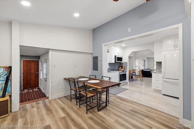 2231 N St, Milford, MI 48380 - dining room featuring electric panel, light wood-type flooring, recessed lighting, and lofted ceiling