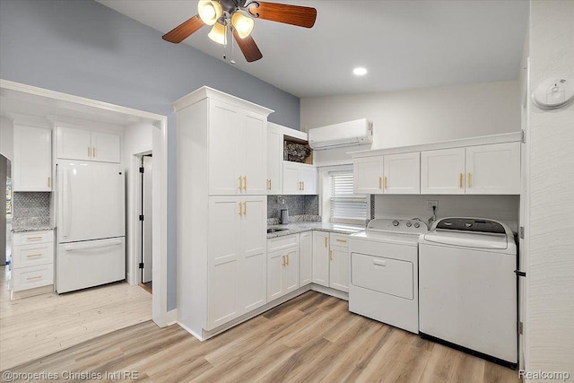 2231 N St, Milford, MI 48380 - washroom featuring washer and clothes dryer, an AC wall unit, a ceiling fan, light wood-type flooring, and recessed lighting