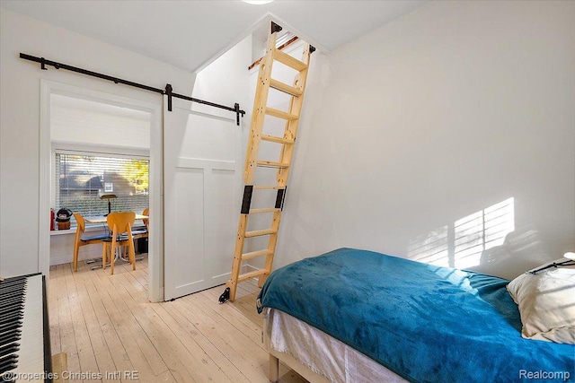 2231 N St, Milford, MI 48380 - bedroom with hardwood / wood-style floors and a barn door