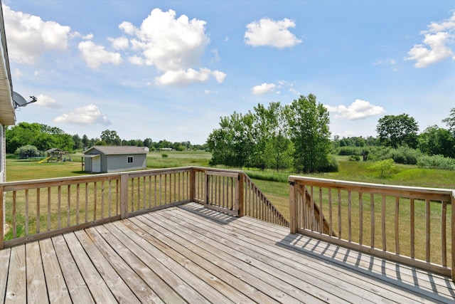 14704 Crescent Meadows Dr, Cedar Springs, MI 49319 - deck featuring a lawn, an outdoor structure, and view of wooded area