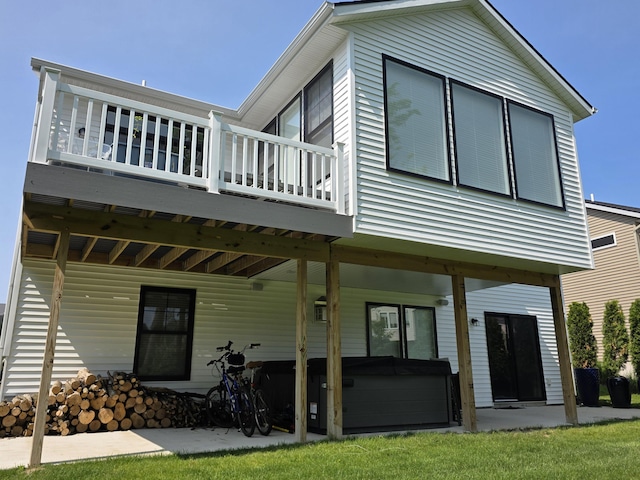3076 Brayridge Dr, Jenison, MI 49428 - rear view of property with a hot tub, a wooden deck, and a patio area