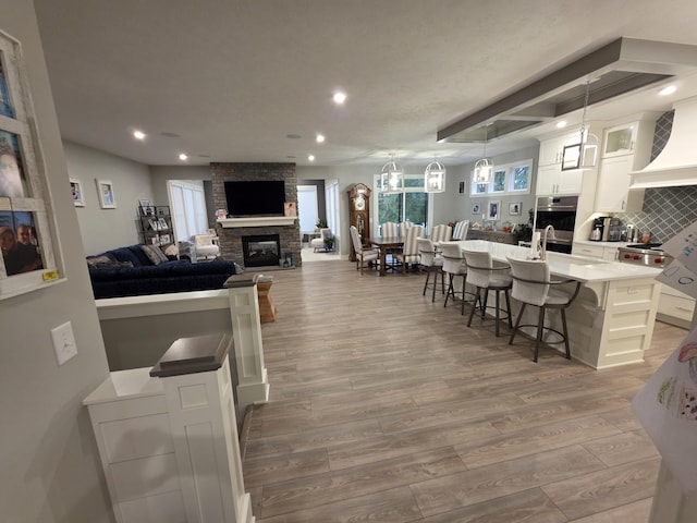 3076 Brayridge Dr, Jenison, MI 49428 - living room featuring wood finished floors, a fireplace, and recessed lighting
