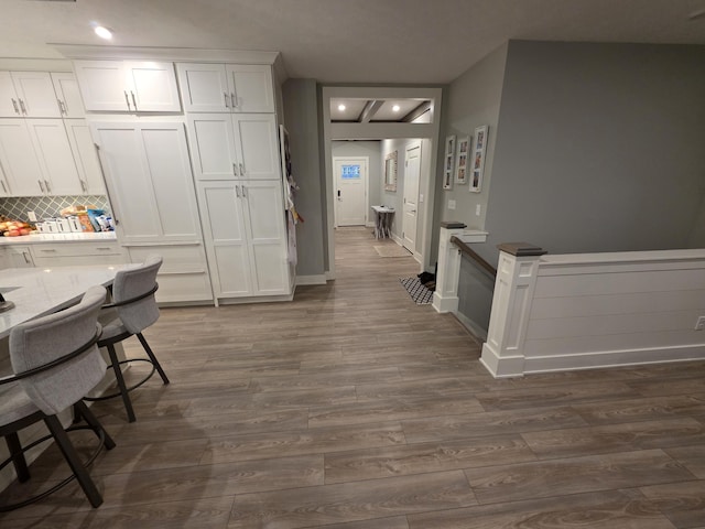 3076 Brayridge Dr, Jenison, MI 49428 - kitchen with dark wood-style flooring, white cabinets, tasteful backsplash, recessed lighting, and light countertops