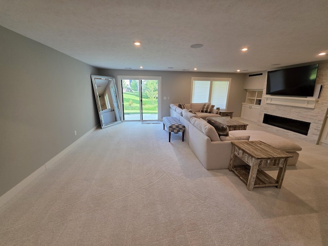 3076 Brayridge Dr, Jenison, MI 49428 - living area with light colored carpet, a fireplace, and recessed lighting