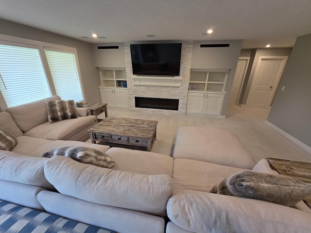 3076 Brayridge Dr, Jenison, MI 49428 - living room featuring a stone fireplace, built in shelves, carpet, and recessed lighting