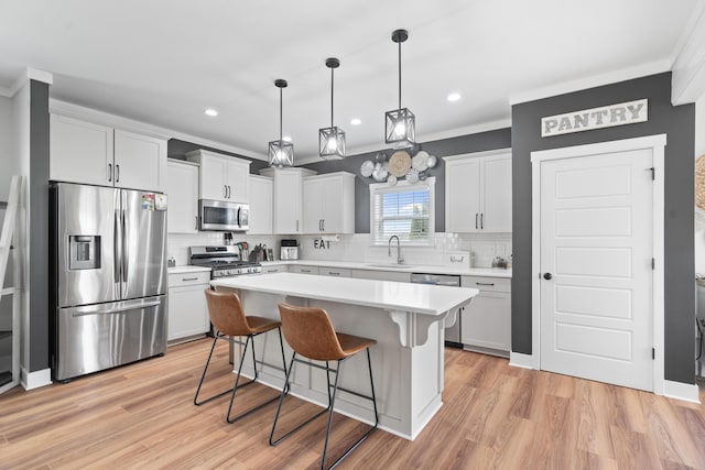 14846 Portage Rd, Vicksburg, MI 49097 - kitchen with stainless steel appliances, backsplash, a breakfast bar area, ornamental molding, and light countertops
