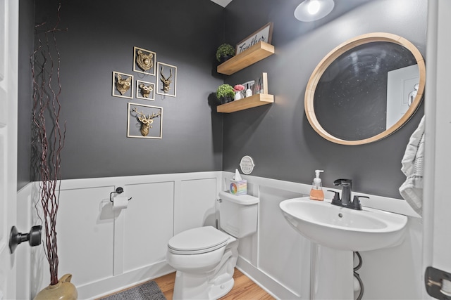 14846 Portage Rd, Vicksburg, MI 49097 - half bath featuring wood finished floors and a wainscoted wall