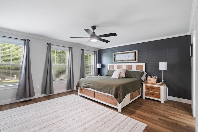 14846 Portage Rd, Vicksburg, MI 49097 - bedroom with multiple windows, wood finished floors, ornamental molding, brick wall, and ceiling fan