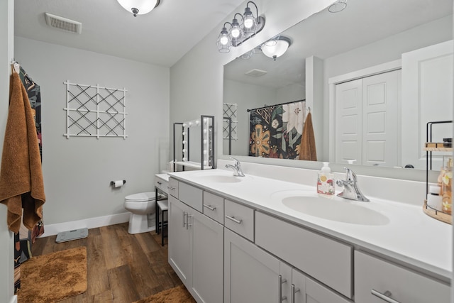 14846 Portage Rd, Vicksburg, MI 49097 - bathroom featuring double vanity, wood finished floors, and a shower with shower curtain