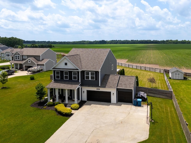 14846 Portage Rd, Vicksburg, MI 49097 - view of front of house with covered porch, concrete driveway, roof with shingles, a garage, and a rural view