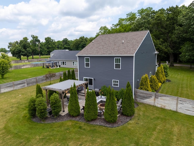 14846 Portage Rd, Vicksburg, MI 49097 - back of house featuring a shingled roof, a fenced backyard, and view of scattered trees