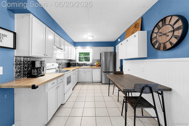 22410 Glen Ct, Saint Clair Shores, MI 48080 - kitchen featuring appliances with stainless steel finishes, decorative backsplash, wooden counters, white cabinetry, and light tile patterned floors