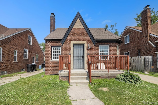 5766 Nottingham Rd, Detroit, MI 48224 - tudor house with brick siding, a chimney, and a shingled roof