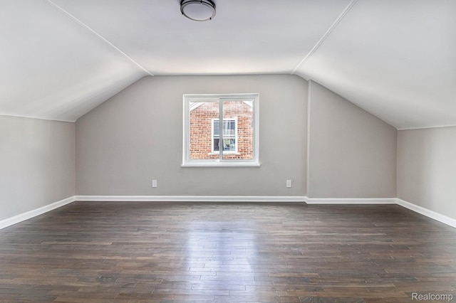 5766 Nottingham Rd, Detroit, MI 48224 - additional living space with vaulted ceiling and dark wood-style flooring