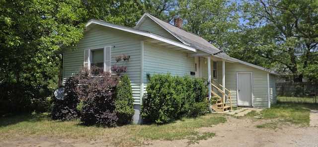 2524 8th St, Muskegon, MI 49444 - view of front of property with a chimney and roof with shingles