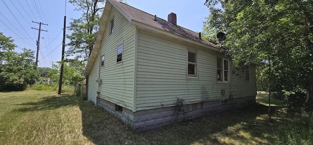 2524 8th St, Muskegon, MI 49444 - view of property exterior with a chimney, a lawn, and roof with shingles