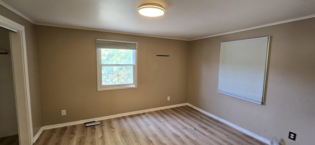 2524 8th St, Muskegon, MI 49444 - unfurnished bedroom with wood finished floors, crown molding, and a closet