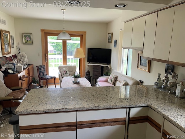 5408 Vincennes Dr, Bloomfield Hills, MI 48302 - kitchen with open floor plan, light stone counters, a peninsula, and hanging light fixtures