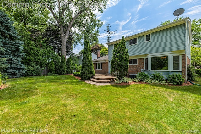683 Thurber Dr, Troy, MI 48085 - rear view of house featuring brick siding and a lawn