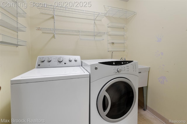 683 Thurber Dr, Troy, MI 48085 - washroom with washer and clothes dryer and light tile patterned floors