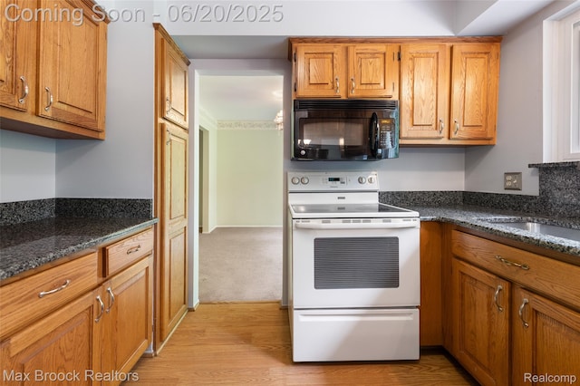 683 Thurber Dr, Troy, MI 48085 - kitchen featuring black microwave, white electric range, light wood-type flooring, brown cabinetry, and dark stone counters