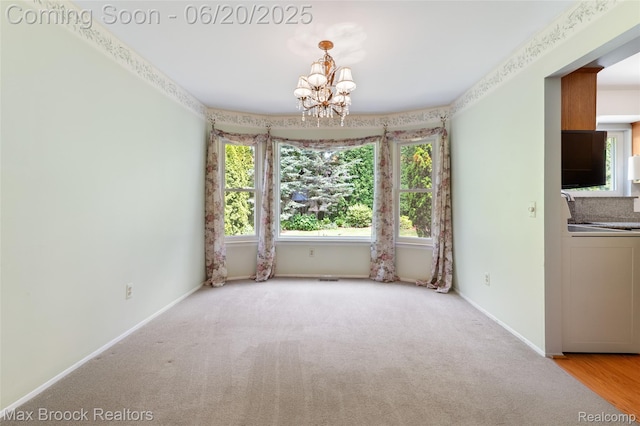683 Thurber Dr, Troy, MI 48085 - carpeted spare room featuring washer / dryer and a chandelier