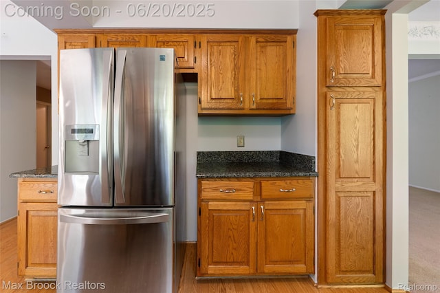 683 Thurber Dr, Troy, MI 48085 - kitchen with stainless steel refrigerator with ice dispenser, brown cabinetry, and dark stone countertops
